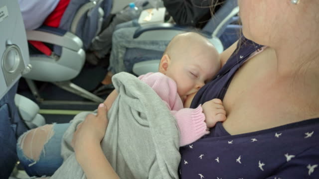 A-Woman-Breastfeeding-her-Child-on-a-Plane