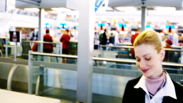 Businesswoman-showing-her-boarding-pass-at-the-check-in-counter
