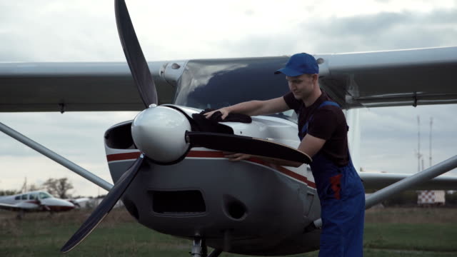 Young-pilot-or-mechanic-working-on-an-aircraft
