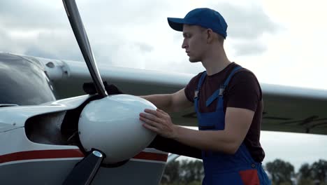 Young-pilot-or-mechanic-working-on-an-aircraft
