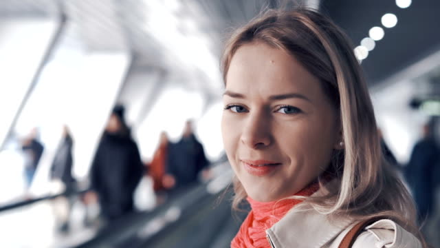 Young-blond-woman-is-riding-on-the-travelator