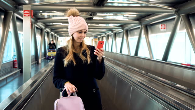 Junge-Frau-mit-Smartphone-in-Flughafen