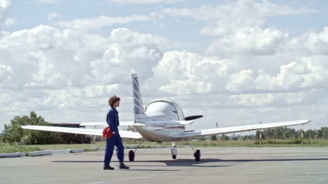Female-Aircraft-Technician-Walking-on-Aerodrome