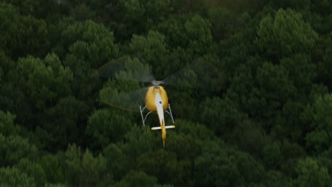 Closeup-aerial-shot-of-helicopter-flying-over-trees.