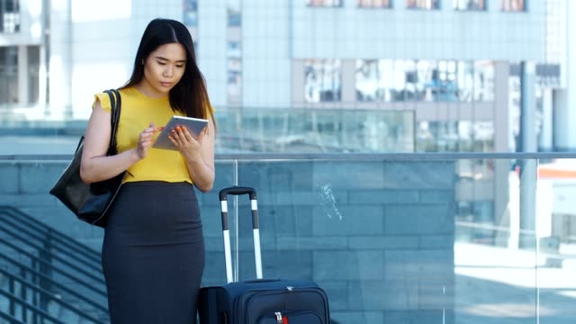 Asiatische-Frau-mit-Touchpad-während-Geschäftsreisen