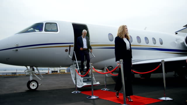 Business-people-leaving-private-jet-4k
