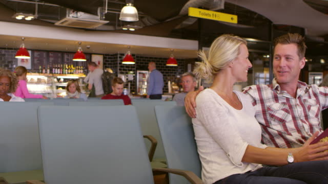 Couple-Waiting-In-Airport-Departure-Lounge-Shot-On-R3D
