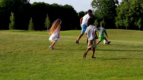 Kids-are-playing-on-evening-glade.
