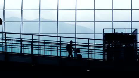 Silhouettes-of-Travelers-in-Airport.