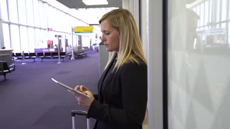 Business-woman-using-digital-tablet-at-airport