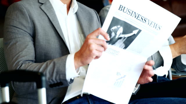 Businessman-holding-newspaper-and-interacting-with-woman