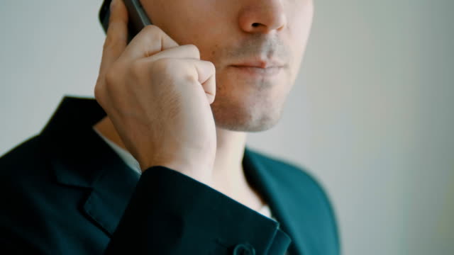 Businessman-walks-off-jet-talking-on-cell-phone