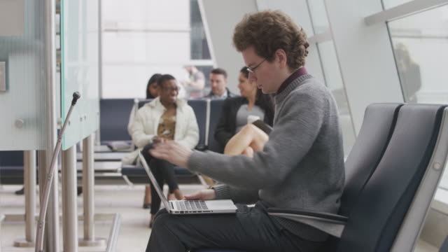 Man-using-laptop-at-airport