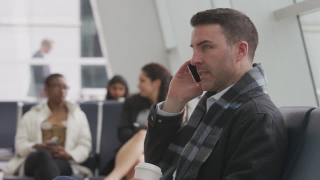 Business-man-talking-on-cell-phone-at-airport