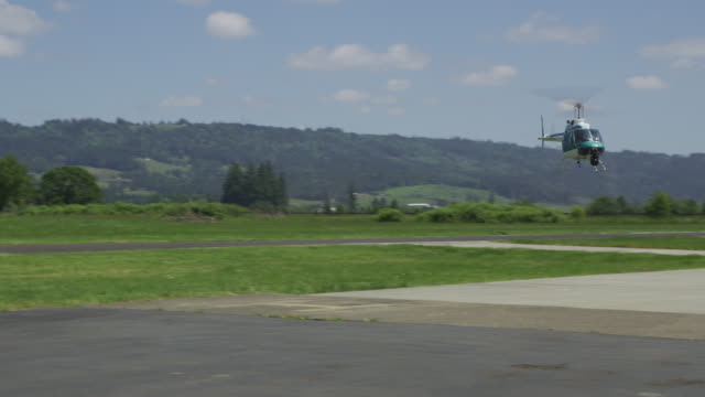 Helicopter-flying-sideways-at-rural-airport.--Shot-with-RED-Epic.