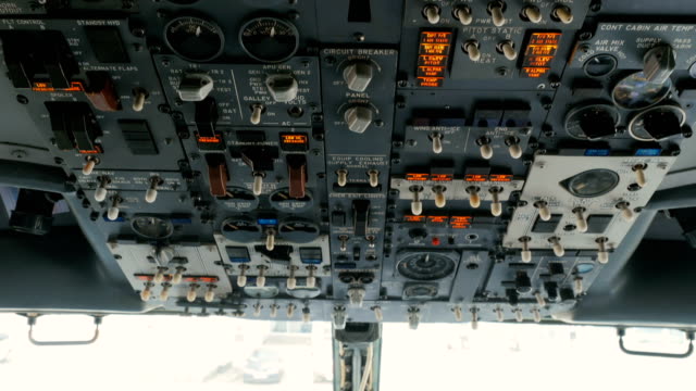 Pilot-pushes-buttons-on-panel-of-airplane