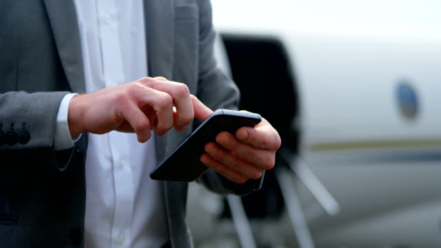 Businessman-using-mobile-phone-at-terminal-4k
