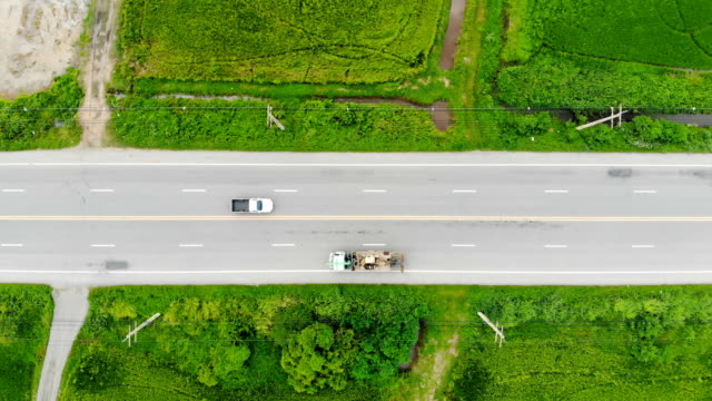 Drone-shot-high-angle-Aerial-view-of-highway-traffic-at-the-countryside,-The-car-truck-and-motorcycle-transport