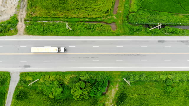 Drone-shot-high-angle-Aerial-view-of-highway-traffic-at-the-countryside,-The-car-truck-and-motorcycle-transport