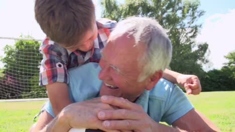 Slow-Motion-Shot-Of-Grandfather-And-Grandson-With-Football