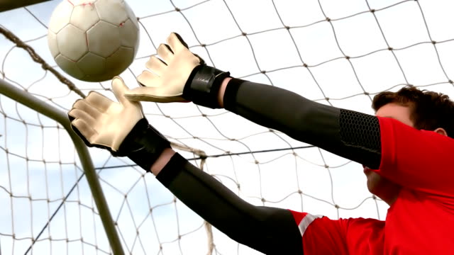 Goalkeeper-in-red-letting-in-goal-during-a-game
