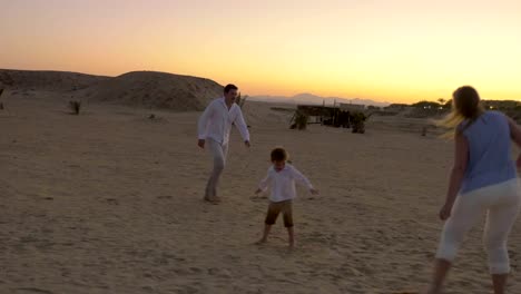 Family-Playing-Football-on-a-Beach