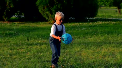Elementary-aged-boy-kicking-ball-in-the-field