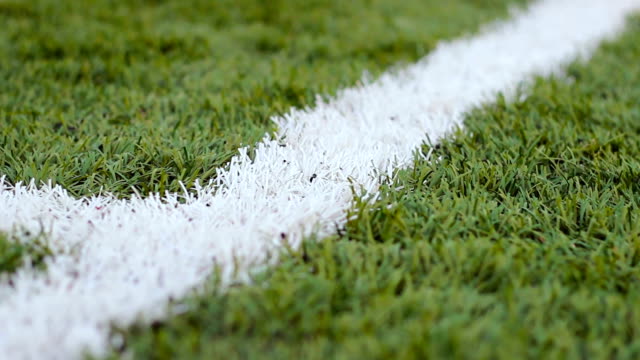 Close-up--of-the-out-of-bounds--line-on--a-turf-football-field