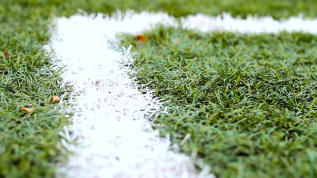 Close-up-of-the-out-of-bounds-line-on-a-turf-football-field