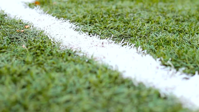 Close-up-of-the-out-of-bounds-line-on-a-turf-football-field