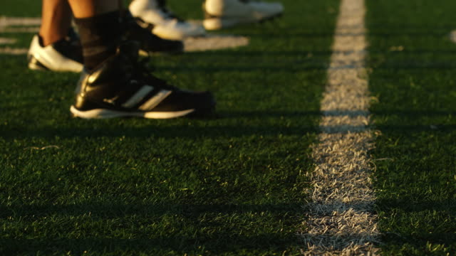 Close-up-of-a-football-player-lining-up-at-the-line-of-scrimmage