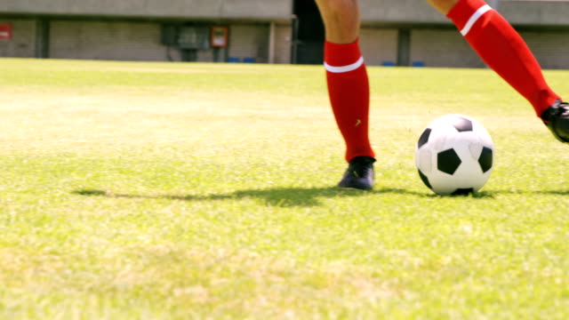 Football-player-dribbling-the-ball
