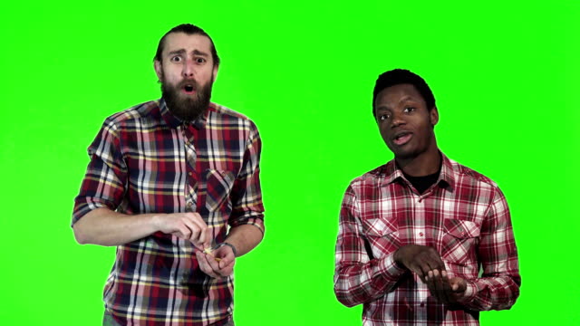 Two-men-eating-french-fries-on-green-screen