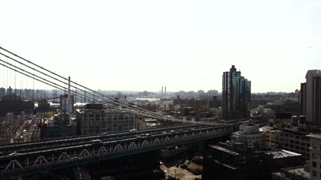 Aerial-view-of-Manhattan-bridge-in-Brooklyn-district.-Drone-flying-over-the-East-river-in-New-York,-America