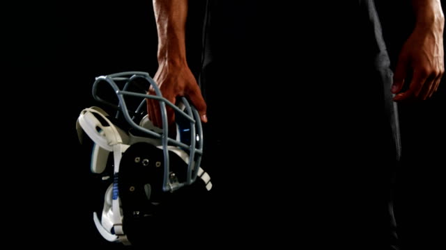 American-football-player-holding-a-head-gear-under-his-arms-4k