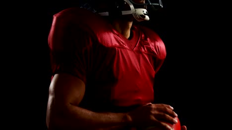 American-football-player-holding-a-ball-with-both-his-hands-4k