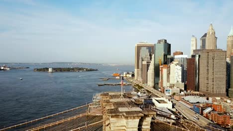 Vista-aérea-de-Manhattan-en-Nueva-York,-América.-Drone-volando-sobre-el-río-del-este,-puente-de-Brooklyn-y-que-agitan-en-la-bandera-de-viento