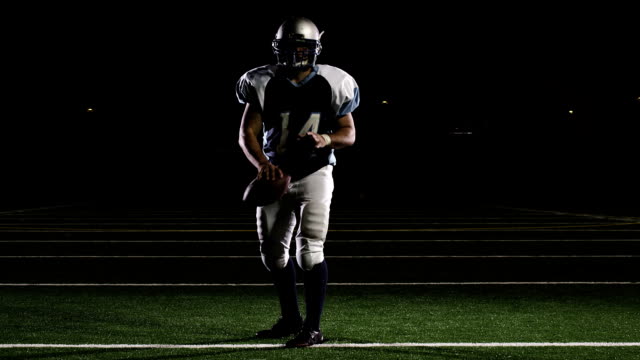 Isolated-quarterback-throws-the-ball-down-the-field-in-front-of-the-camera