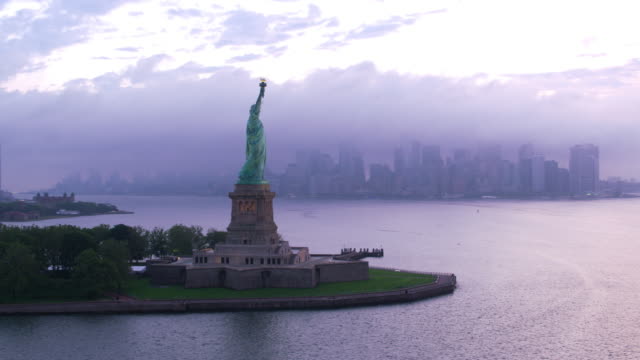 Aerial-orbit-of-Statue-of-Liberty-at-sunrise.