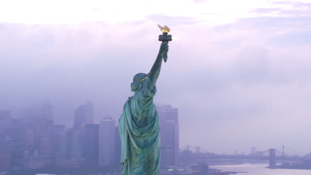 Aerial-orbit-of-Statue-of-Liberty-at-sunrise.