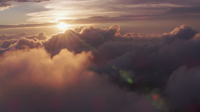 Aerial-view-of-sunrise-over-clouds-with-New-York-City-below.