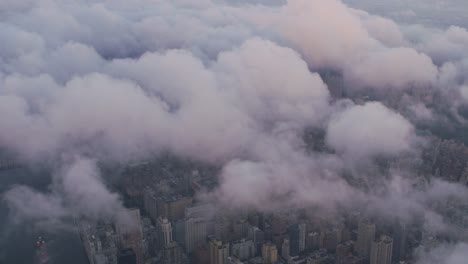 Aerial-view-looking-through-low-clouds-at-Manhattan.