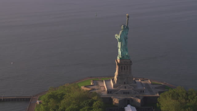 Aerial-view-of-Statue-of-Liberty-at-sunrise,-Manhattan.