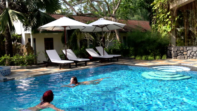 Two-women-swim-in-the-open-air-pool