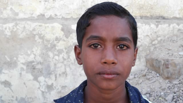 Indian-boy-looking-at-the-camera-and-talking,-handheld