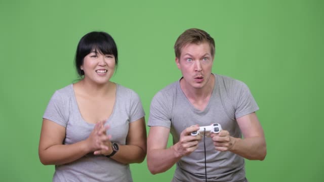 Young-multi-ethnic-couple-playing-games-and-winning-together