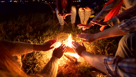The-happy-people-sit-near-the-bonfire.-evening-night-time