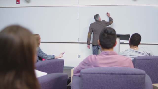 A-professor-begins-class-by-writing-on-the-whiteboard