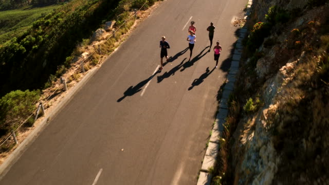 Group-of-athletic-friends-running-outdoors