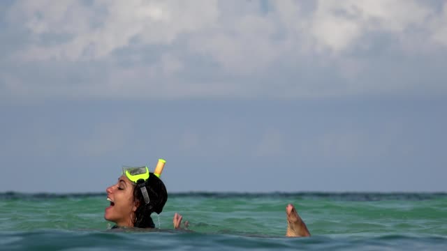 Fun-Couple-Swimming-In-Ocean-On-Vacation